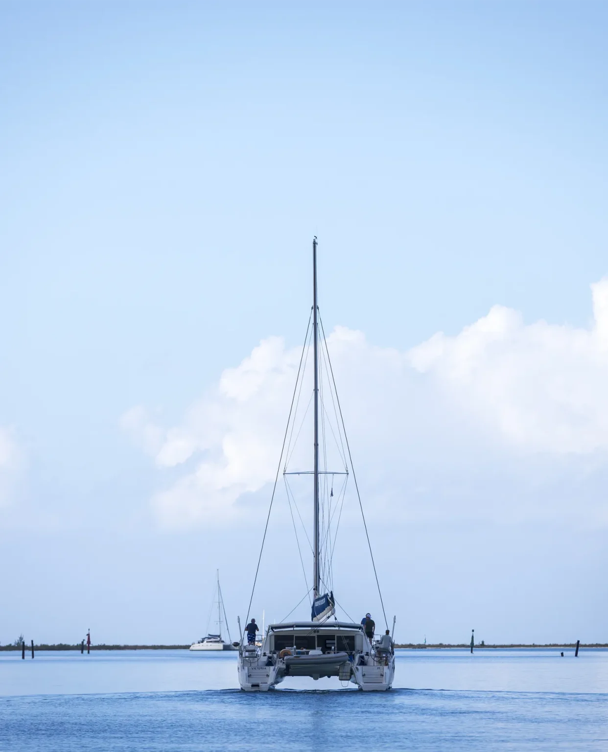 Catamaran Purboat Karribean quittant un mouillage paisible au petit matin.